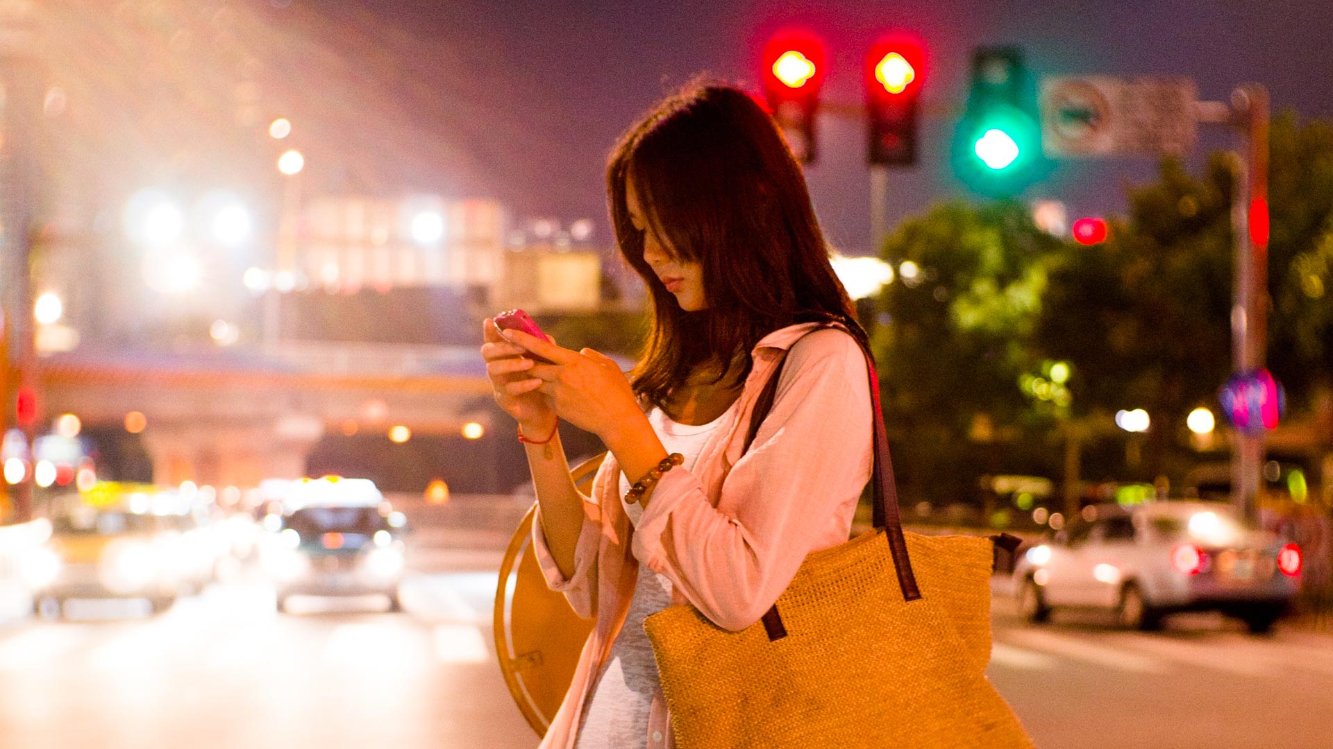Girl on phone at night at stoplights