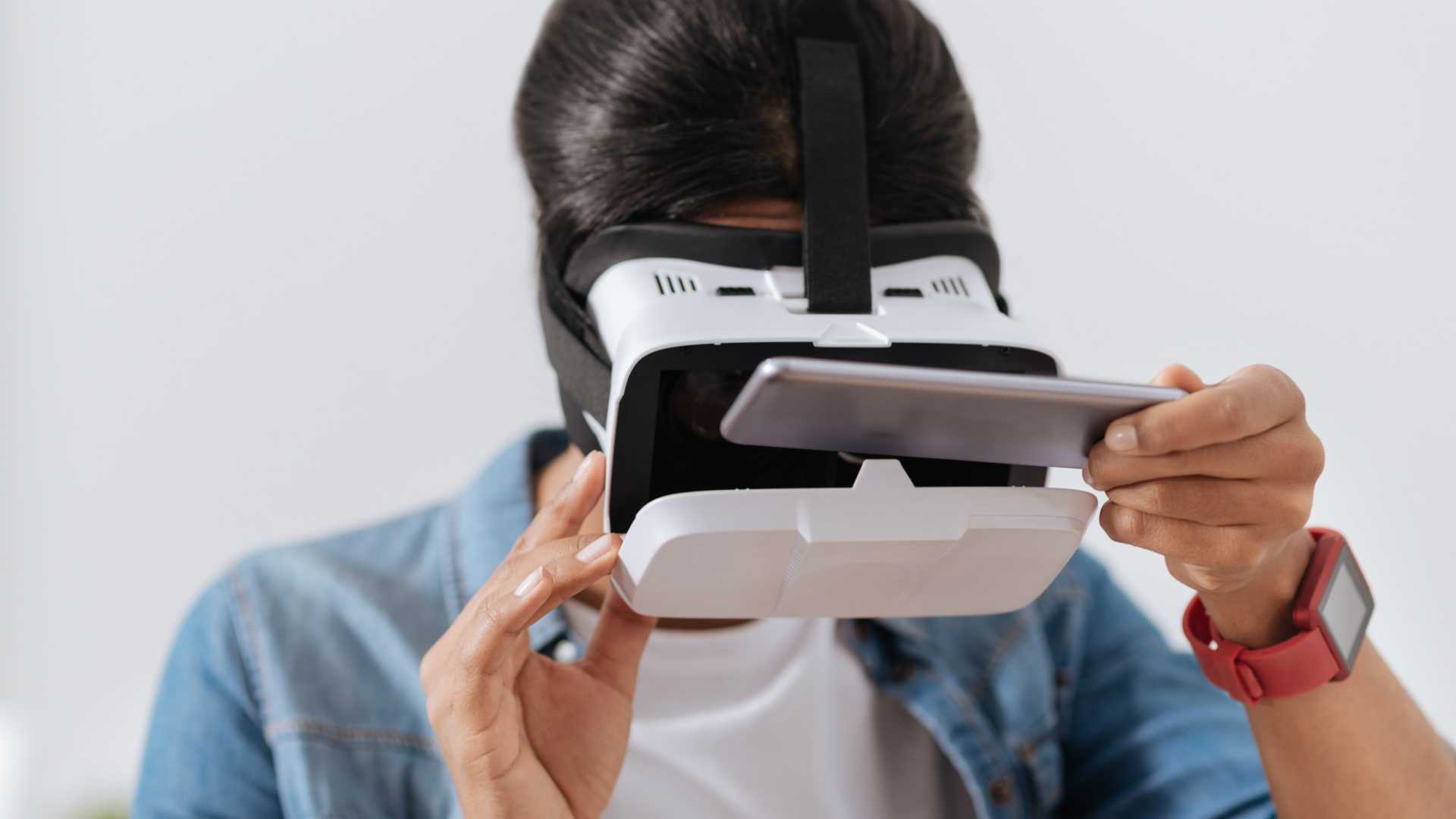 woman looking into VR glasses with a mobile phone