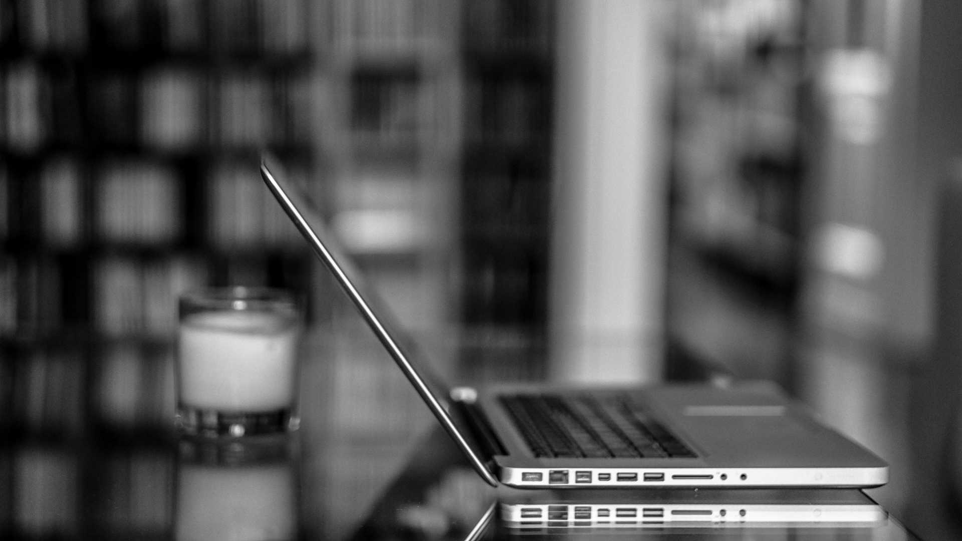 black and white photo of a laptop on a table
