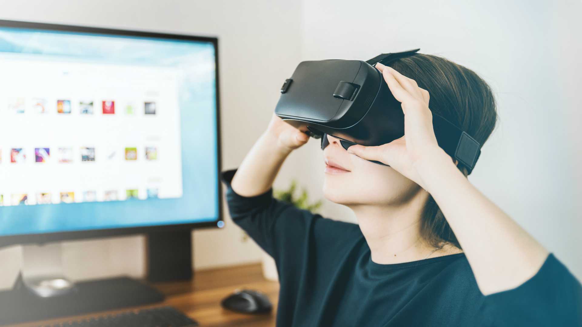 woman using VR headset at her desk
