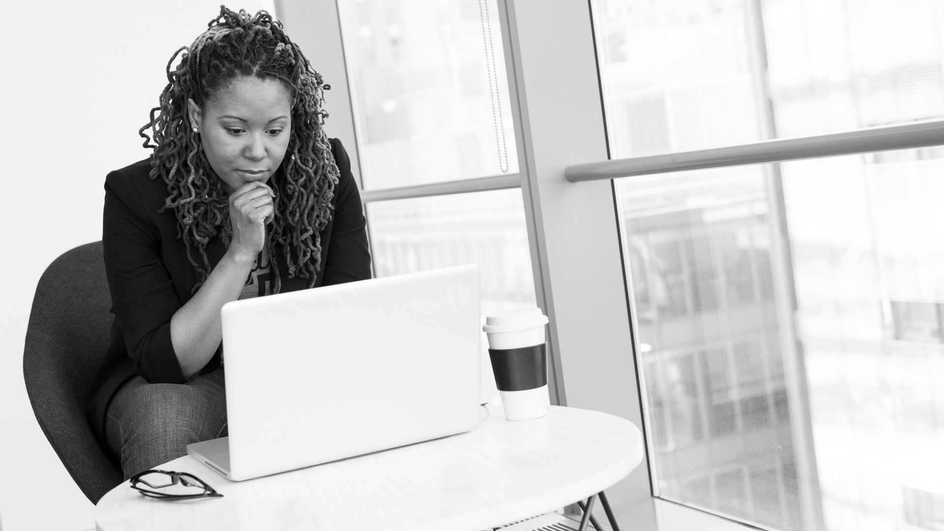 woman watching a video thoughtfully on a laptop