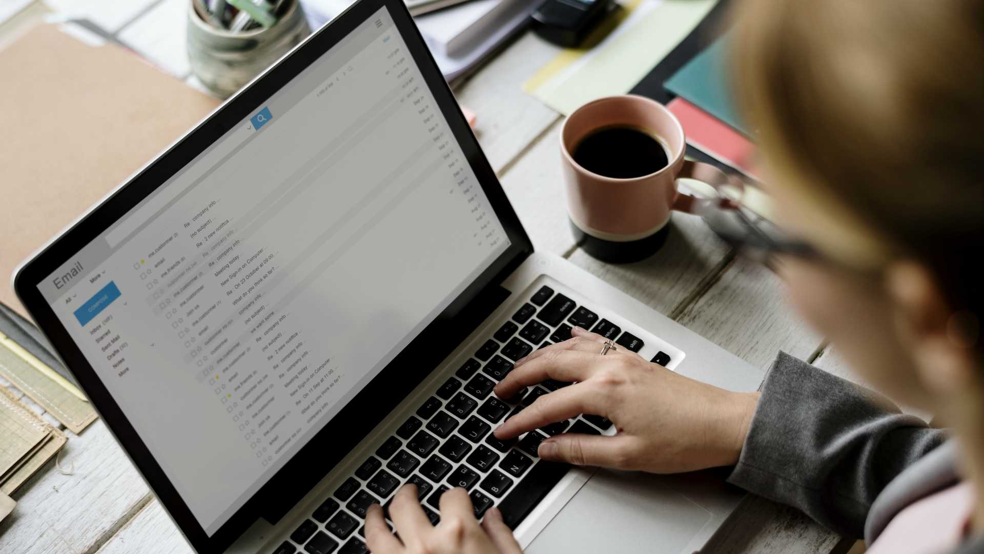 Businesswoman Checking E-mail Online on Laptop
