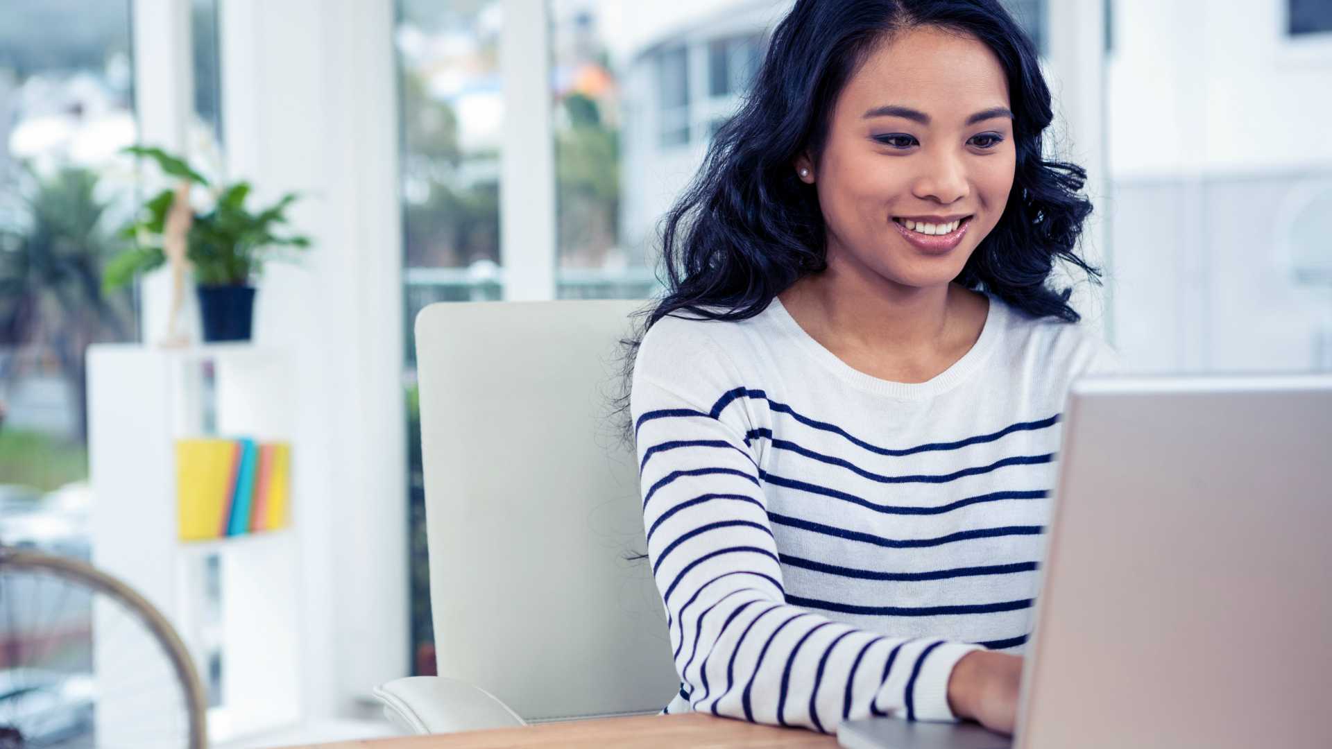 young woman working on a laptop