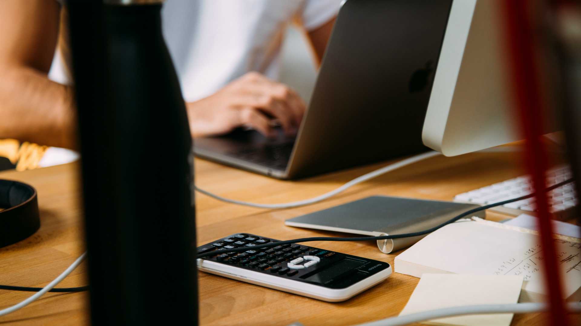 woman at work with a laptop and a calculator