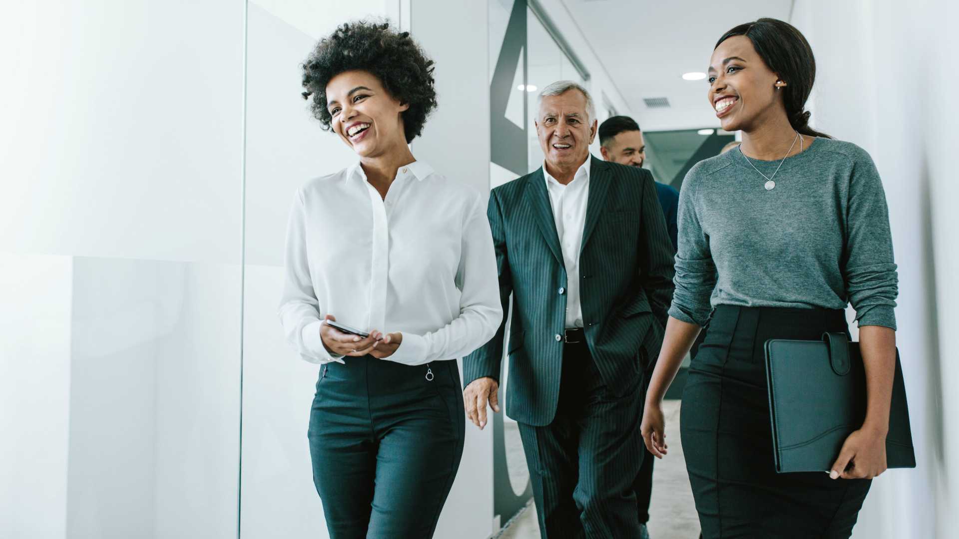 Businesspeople walking through office corridor