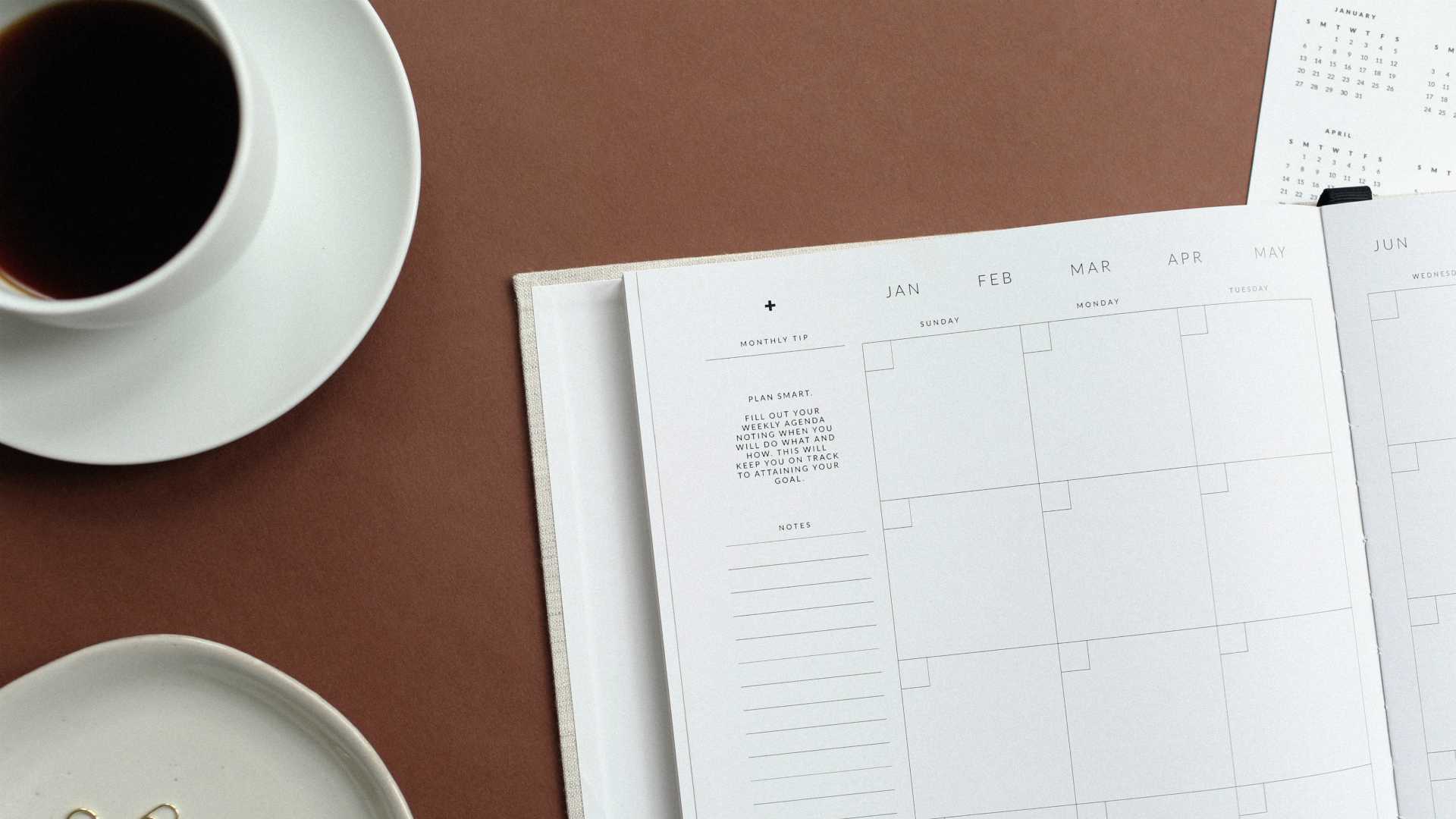 planner and cup of coffee on a desk