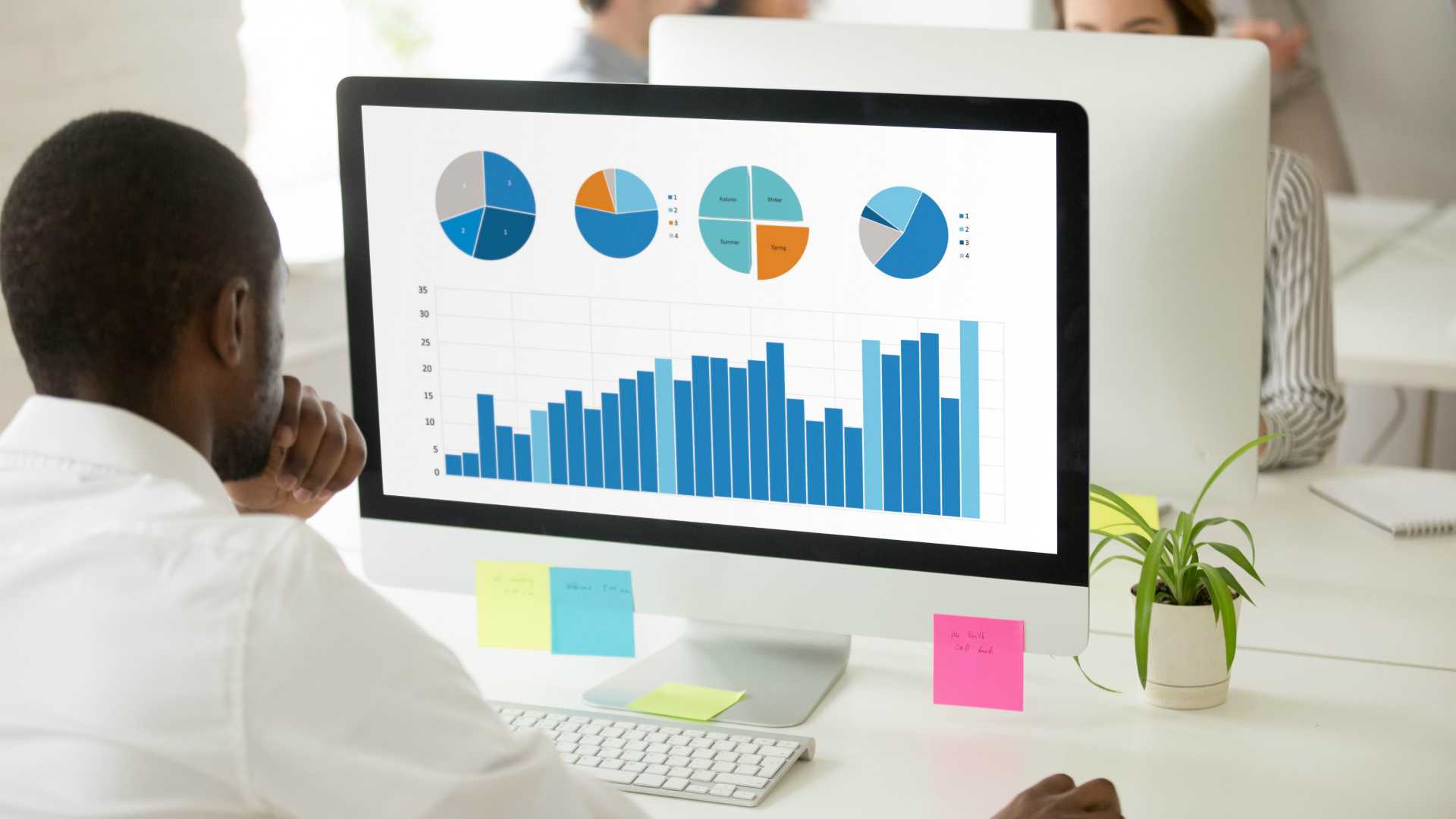 African-American businessman looking at charts on a computer