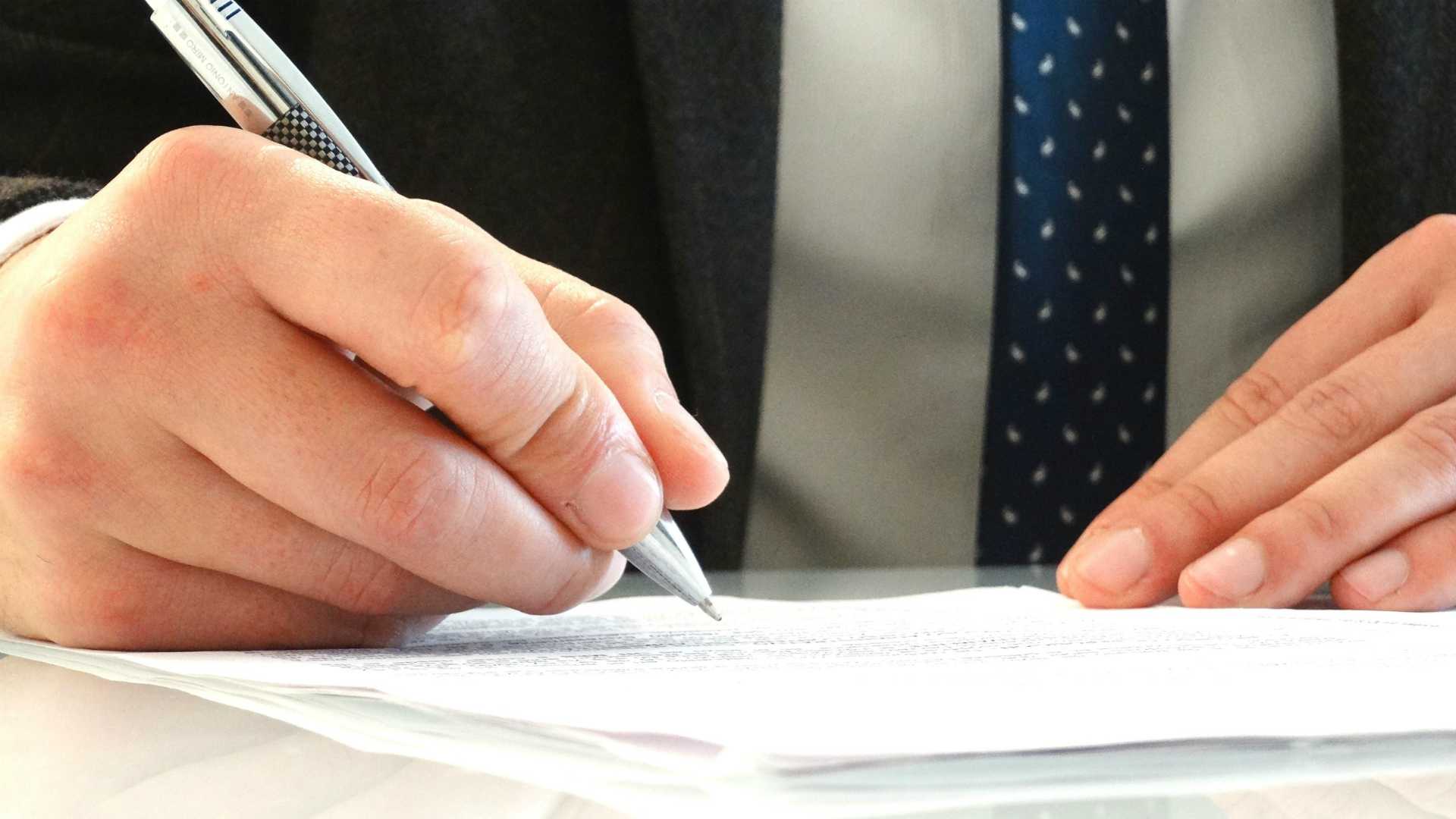 close-up of businessman's hands signing a paper