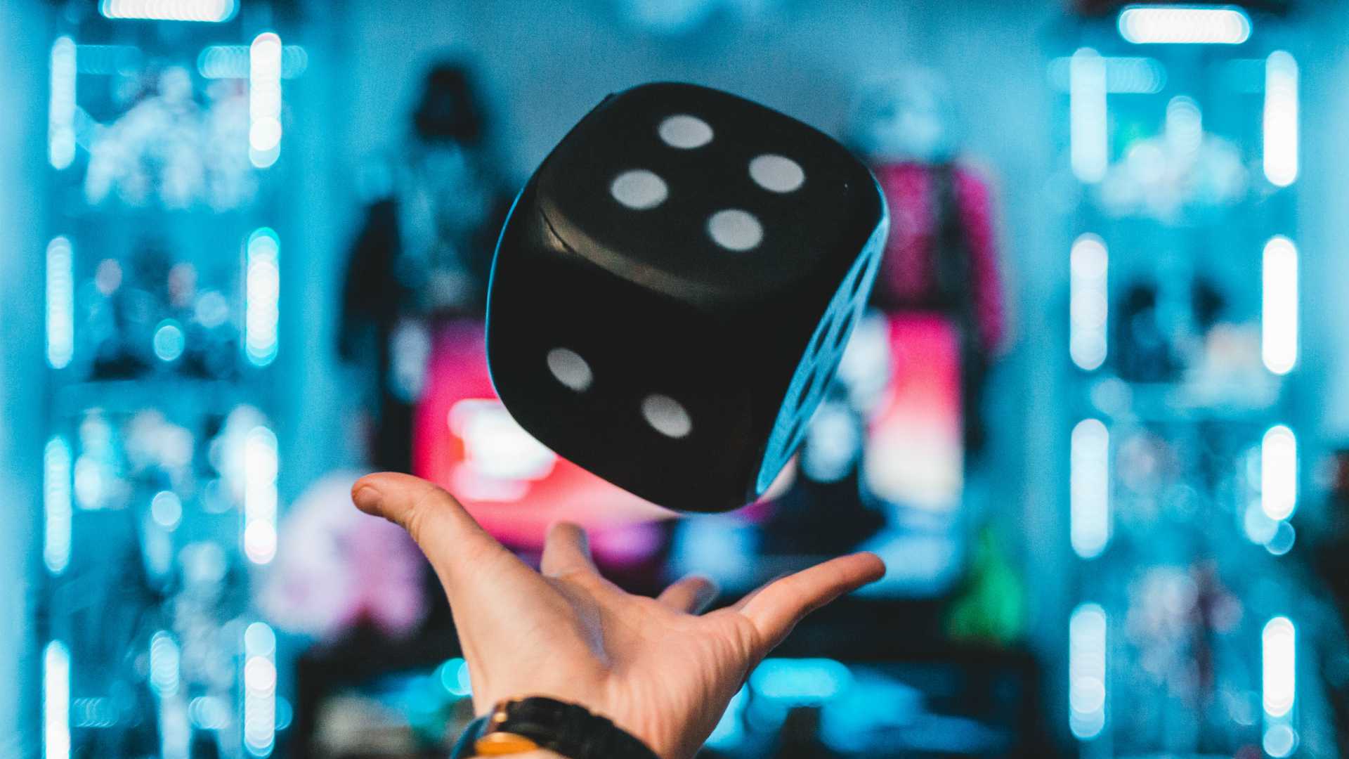 person rolling a large dice