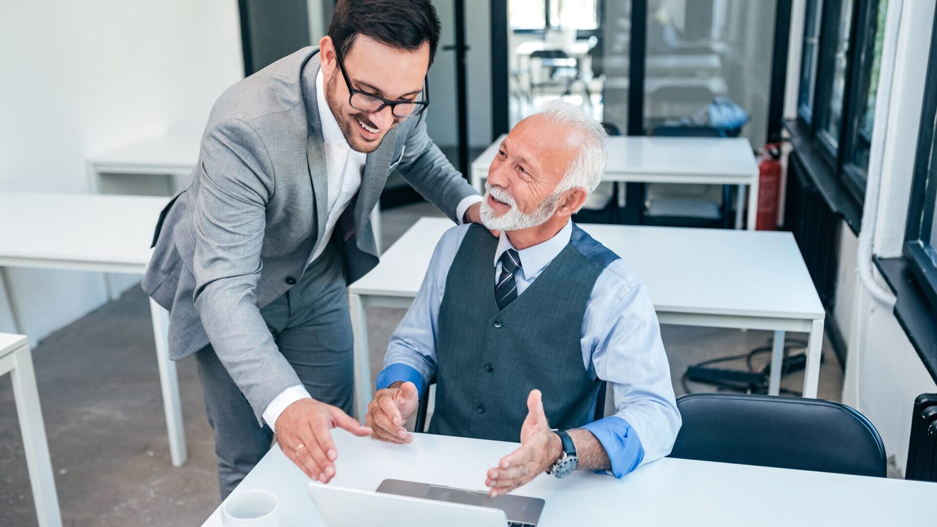 Senior boss happy for good online work result of young male
