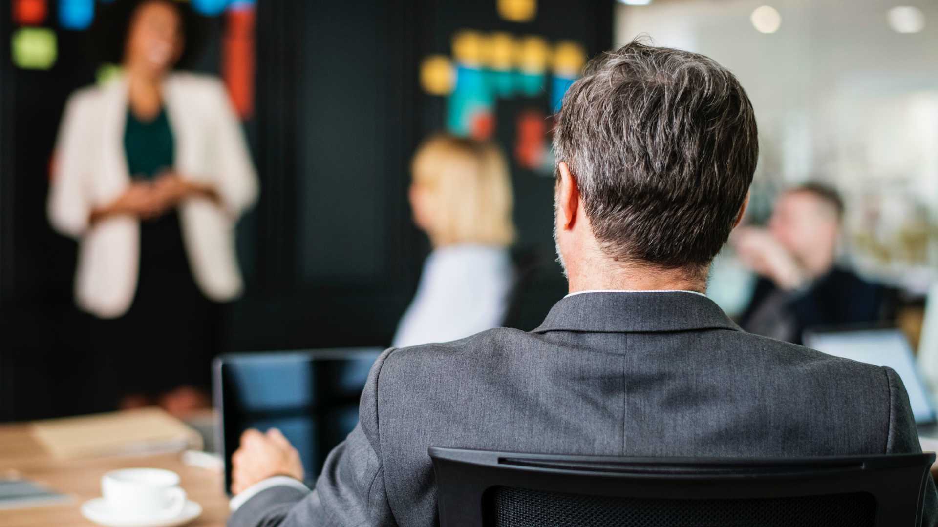 Businessmen and women holding meeting in conference room