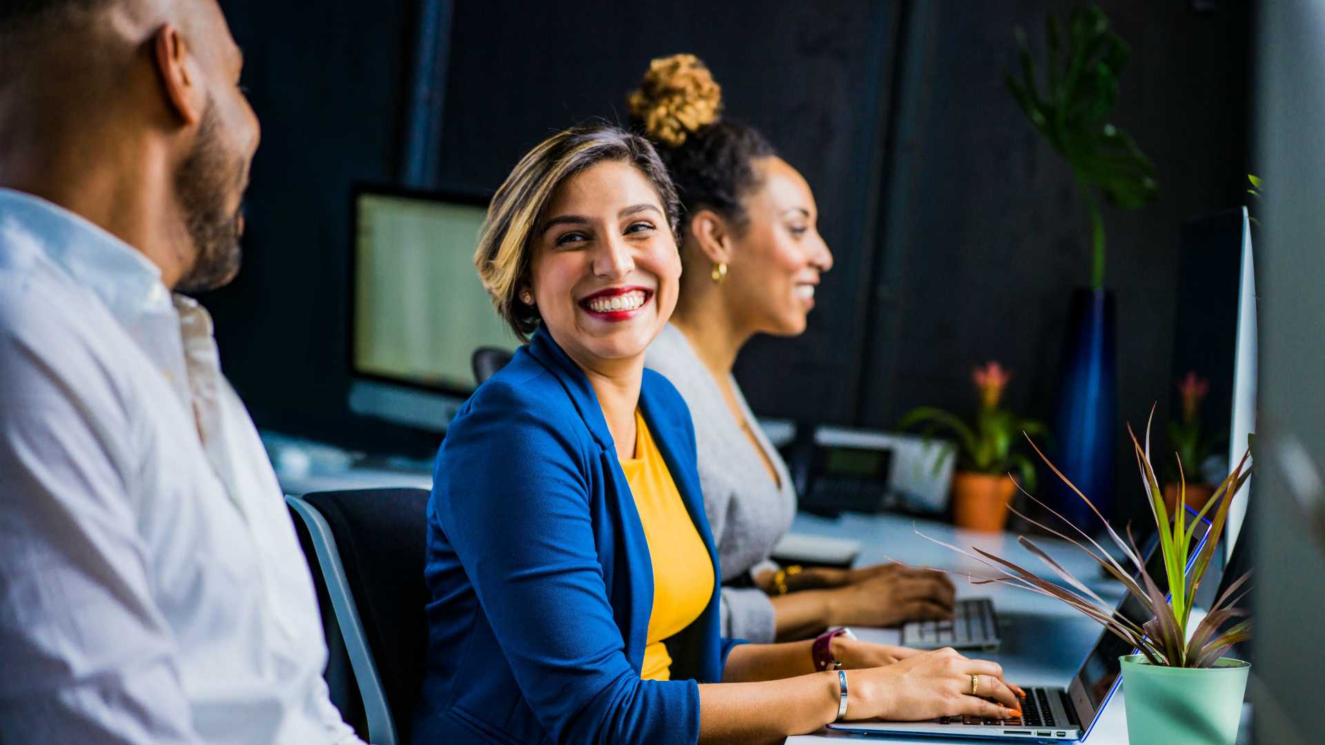 Young businesswoman smiling and chatting with male colleague