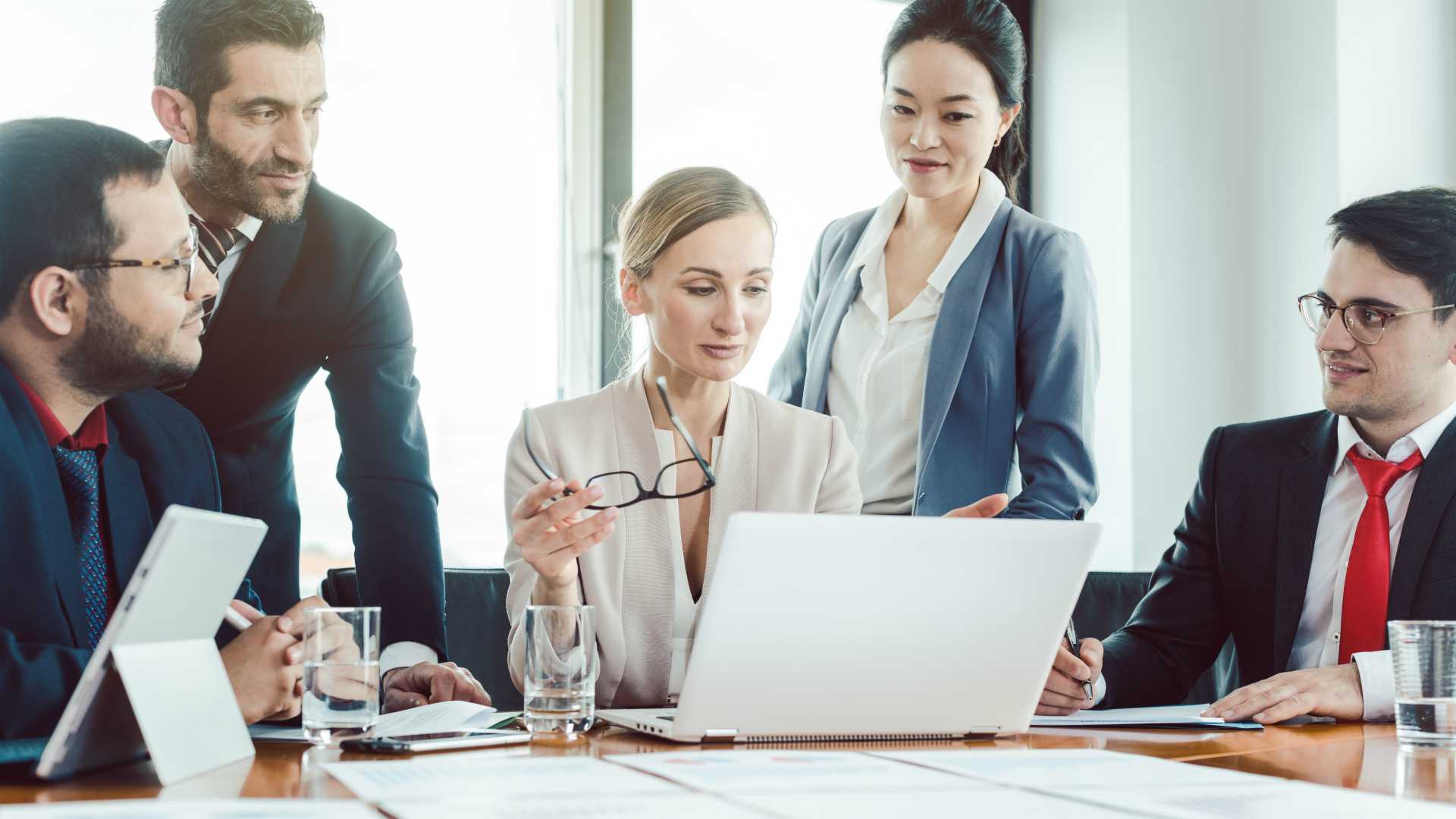 Team leader and her team of diverse people working on a business project