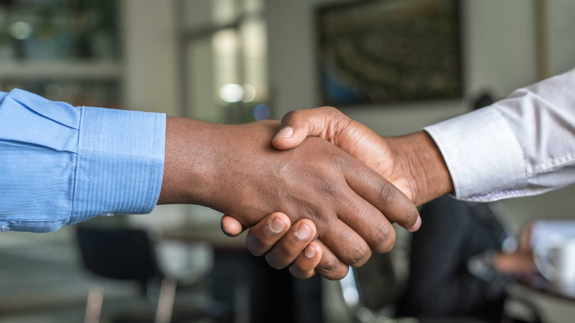 Two businessmen shaking hands, close up shot on hand shake