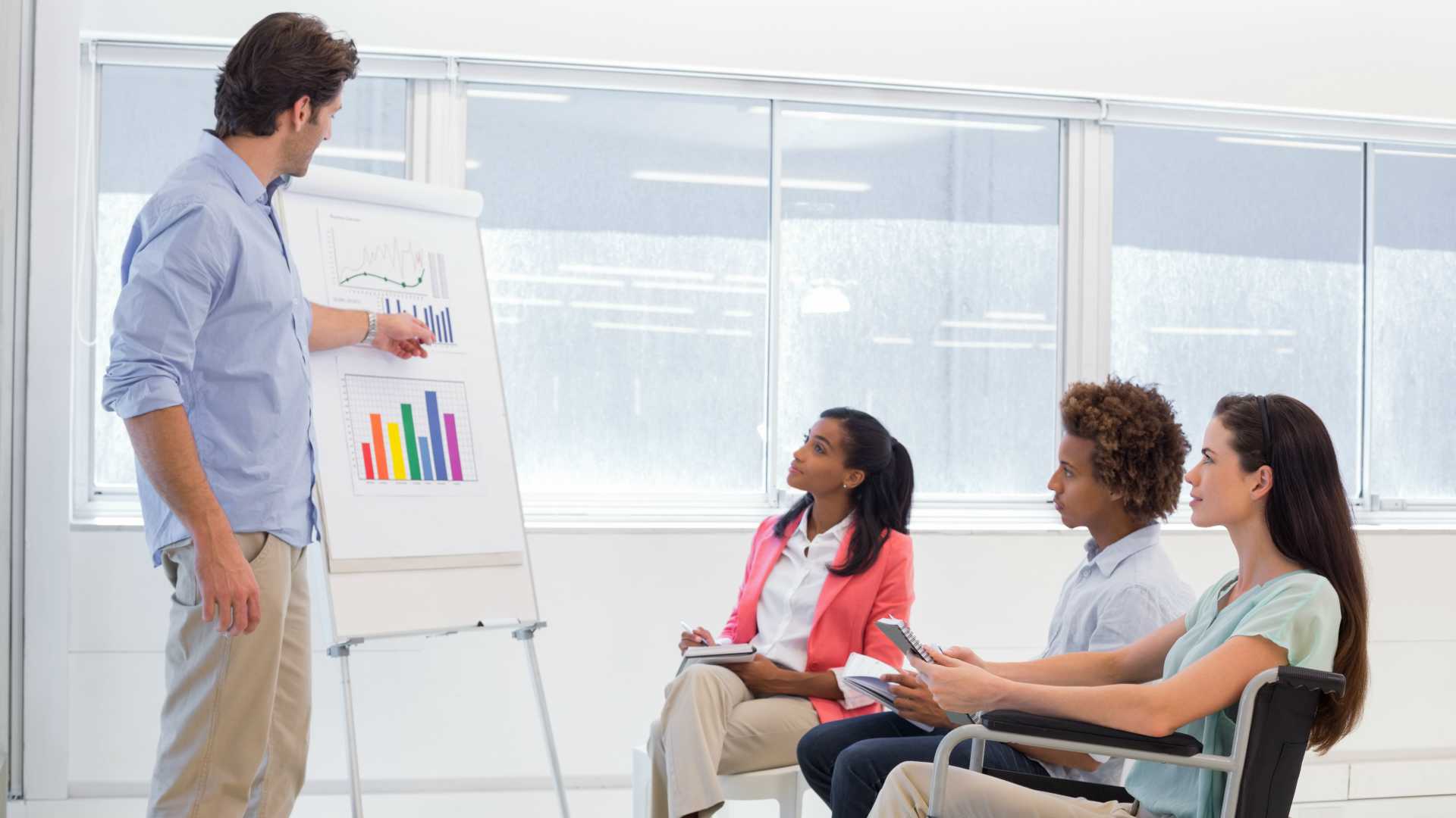 Businessman presenting a graph to his coworkers in the office