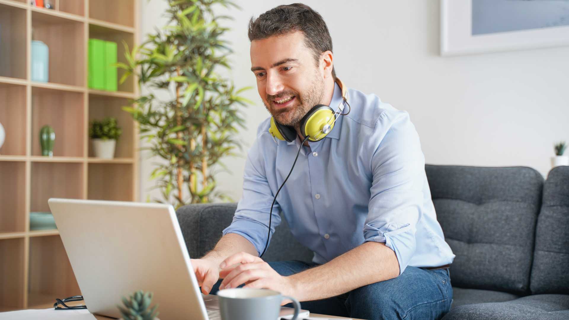 Happy man watching video streaming at home