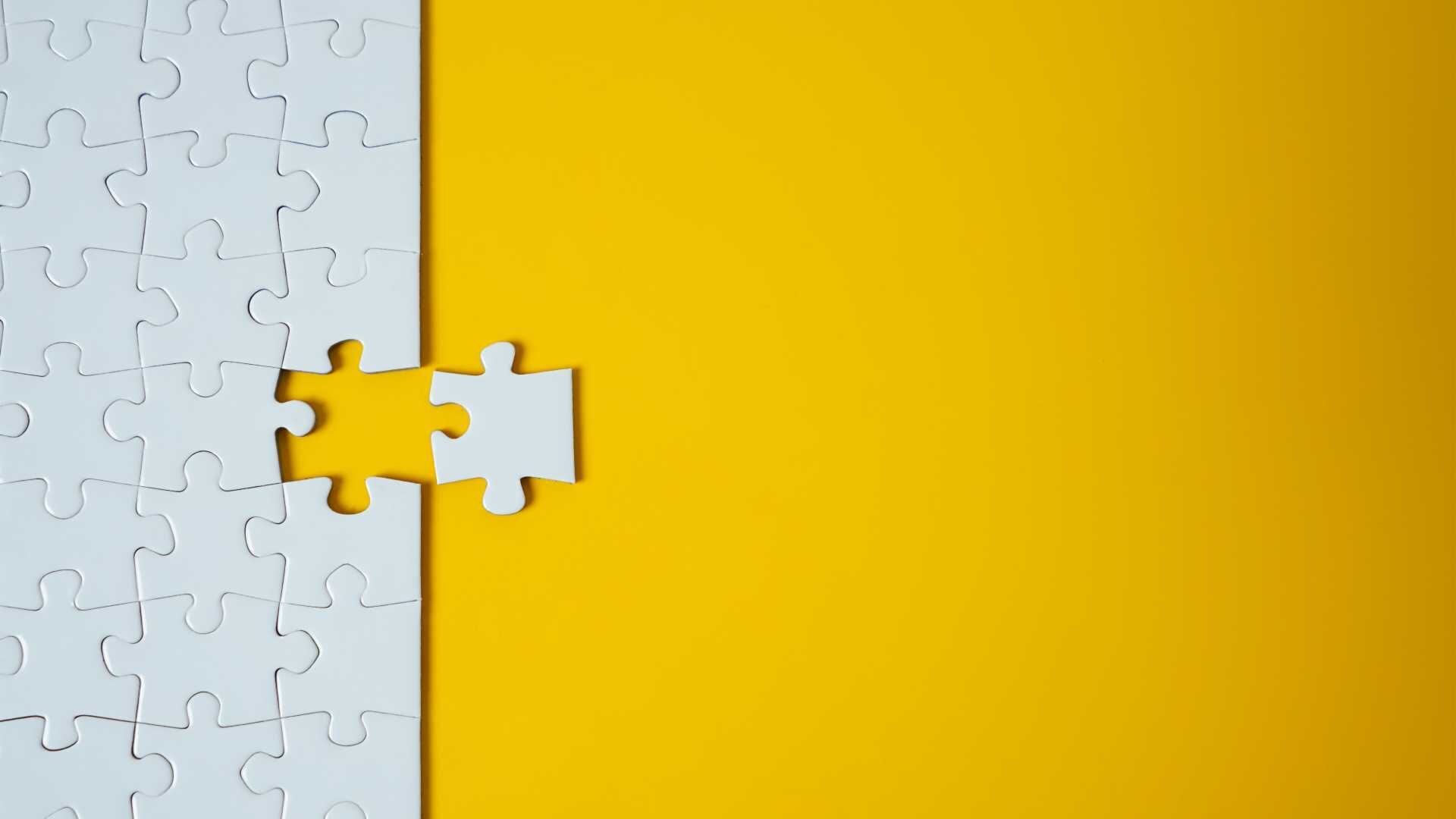 a single puzzle piece completes a blank puzzle, data and analytics