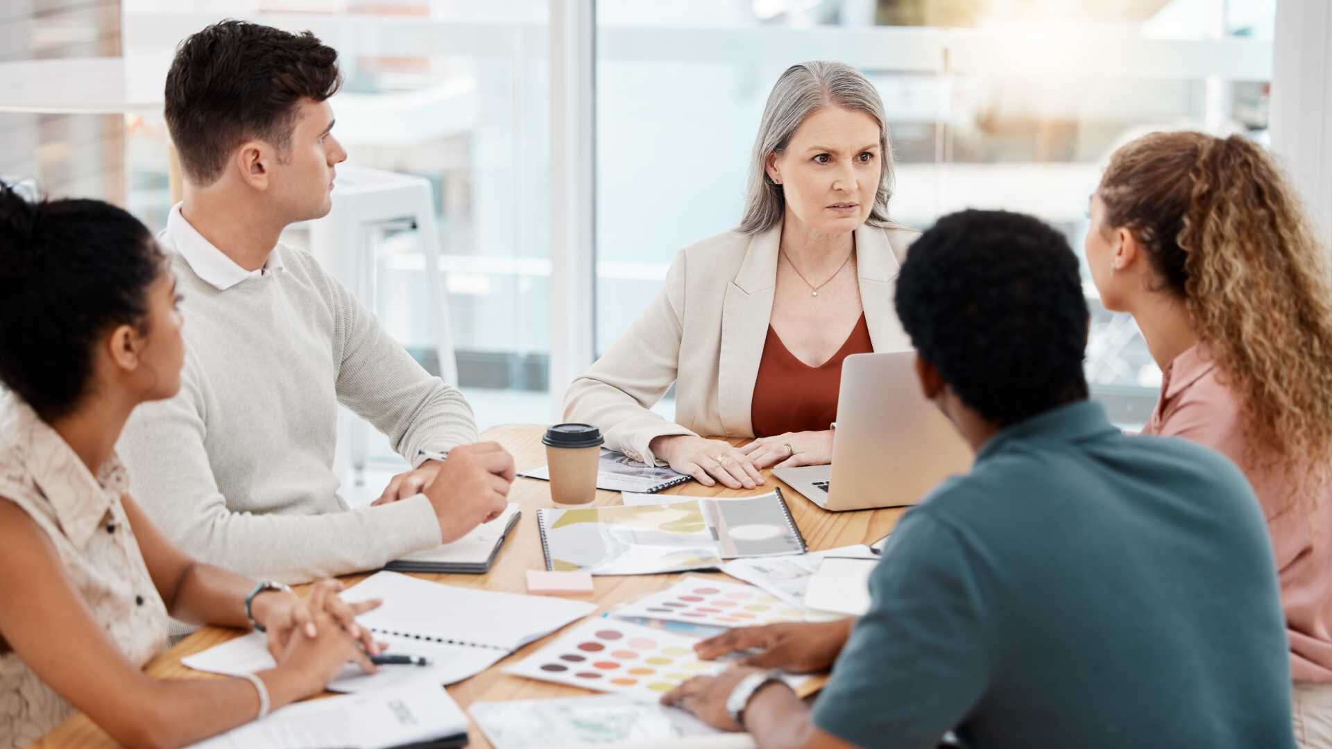 Business professionals sitting around a table.