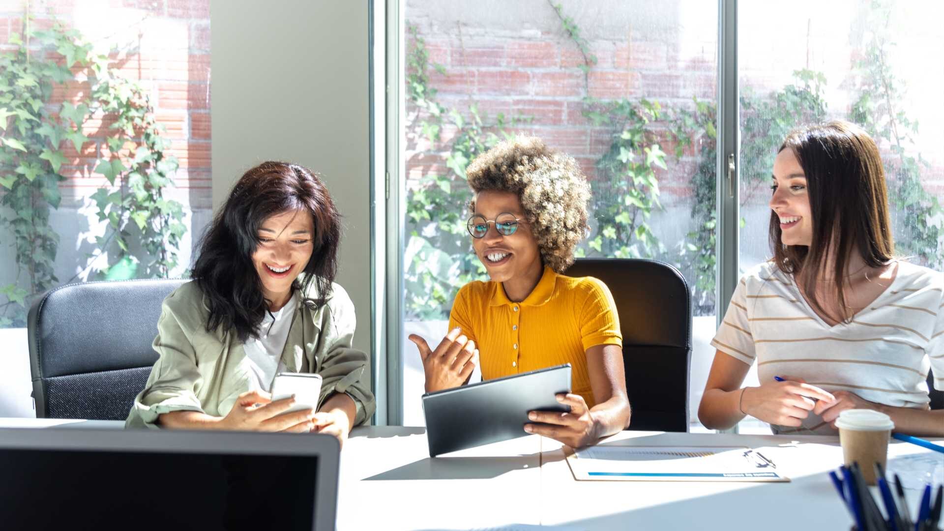 A diverse group of women in a business setting in a conversation