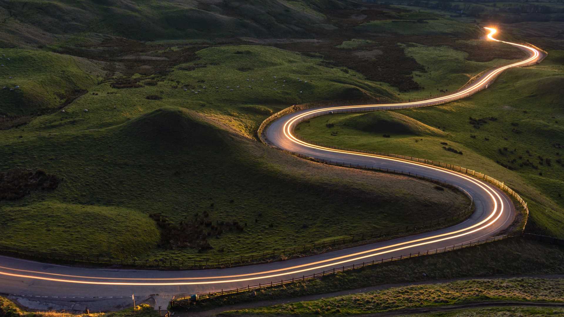 A winding road through green mountains highlighting a path forward