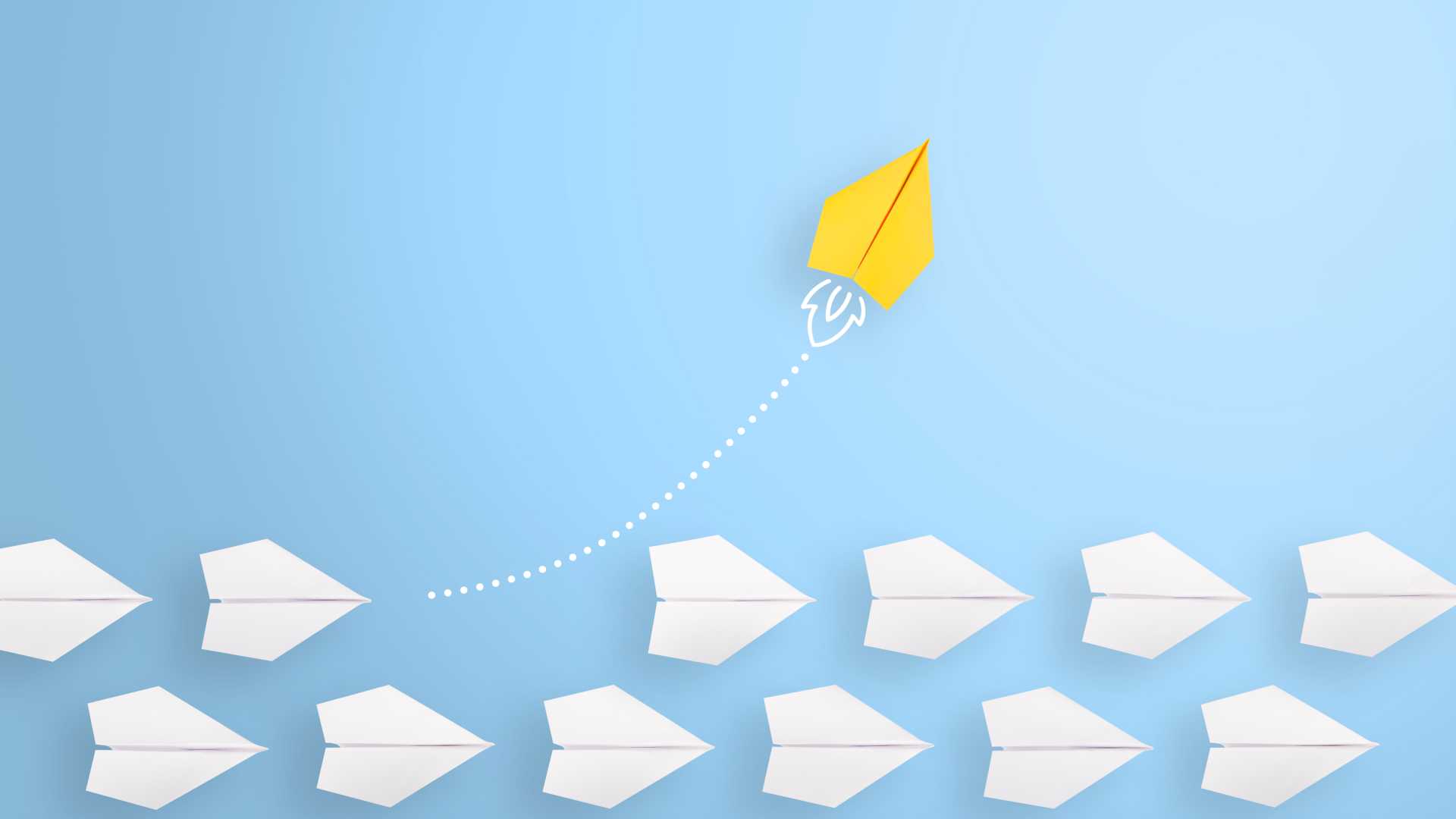 Blue background with white paper airplanes going in one linear direction and a yellow paper airplane shooting upwards.