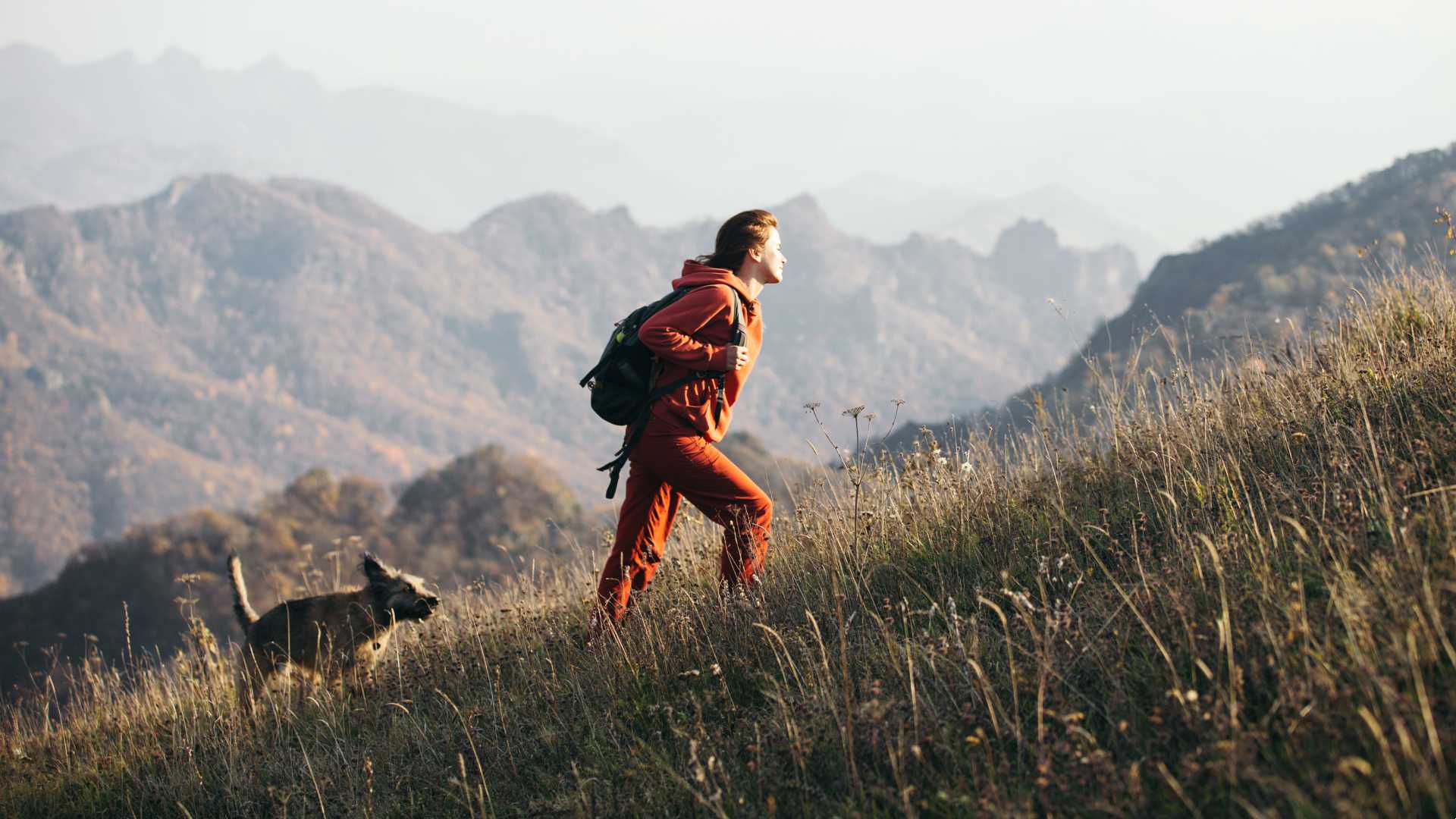 A female hiker climbing an uphill mountain