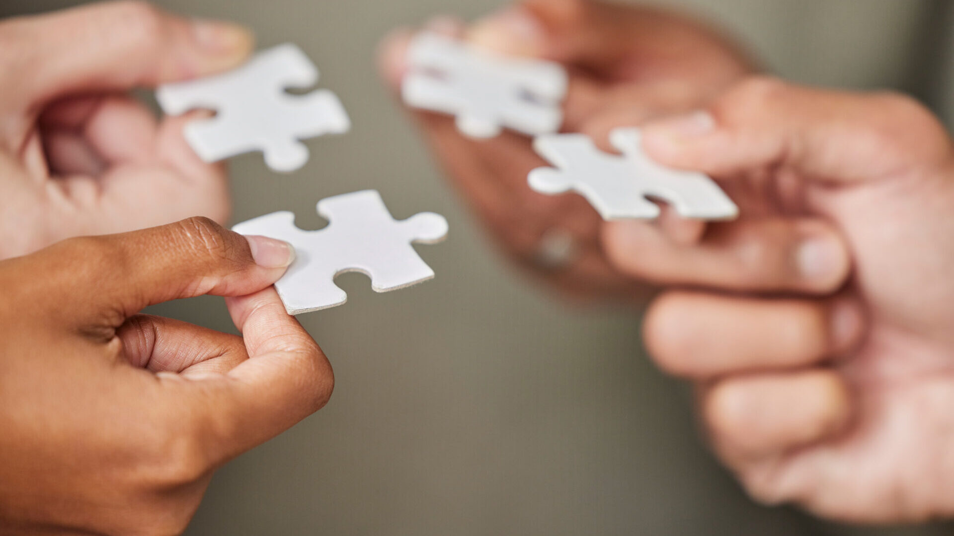 business people holding puzzle pieces and problem-solving