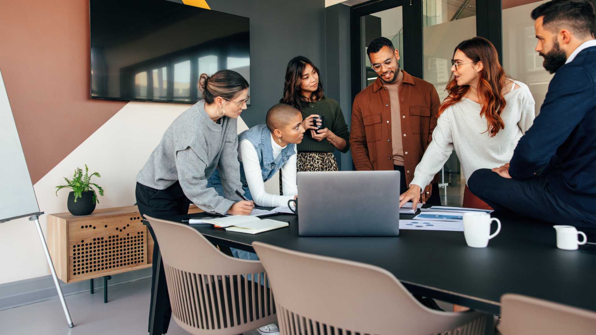 Collaborative team of leaders planning and brainstorming an approach in the workplace conference room.