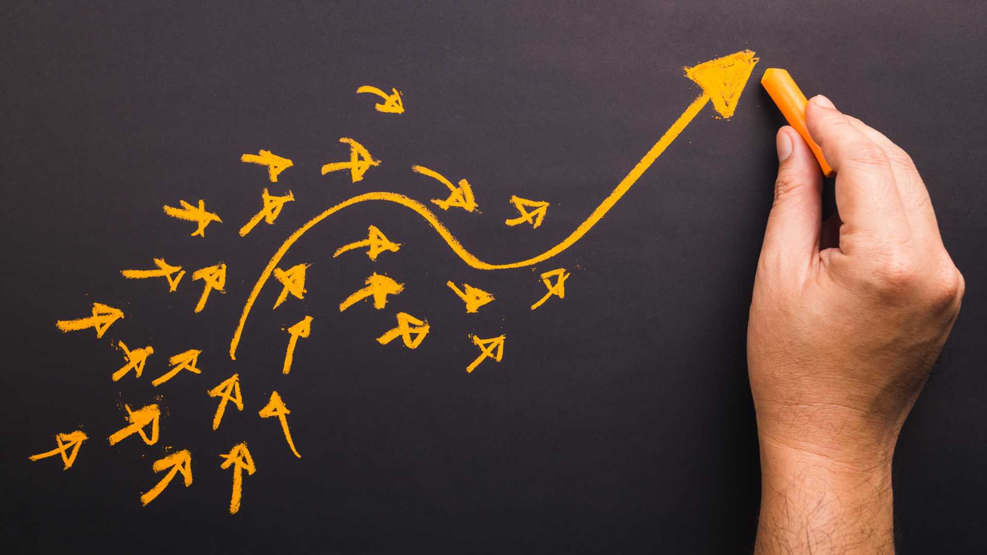 Hand draw a curve arrow leader with many small arrows following on chalkboard