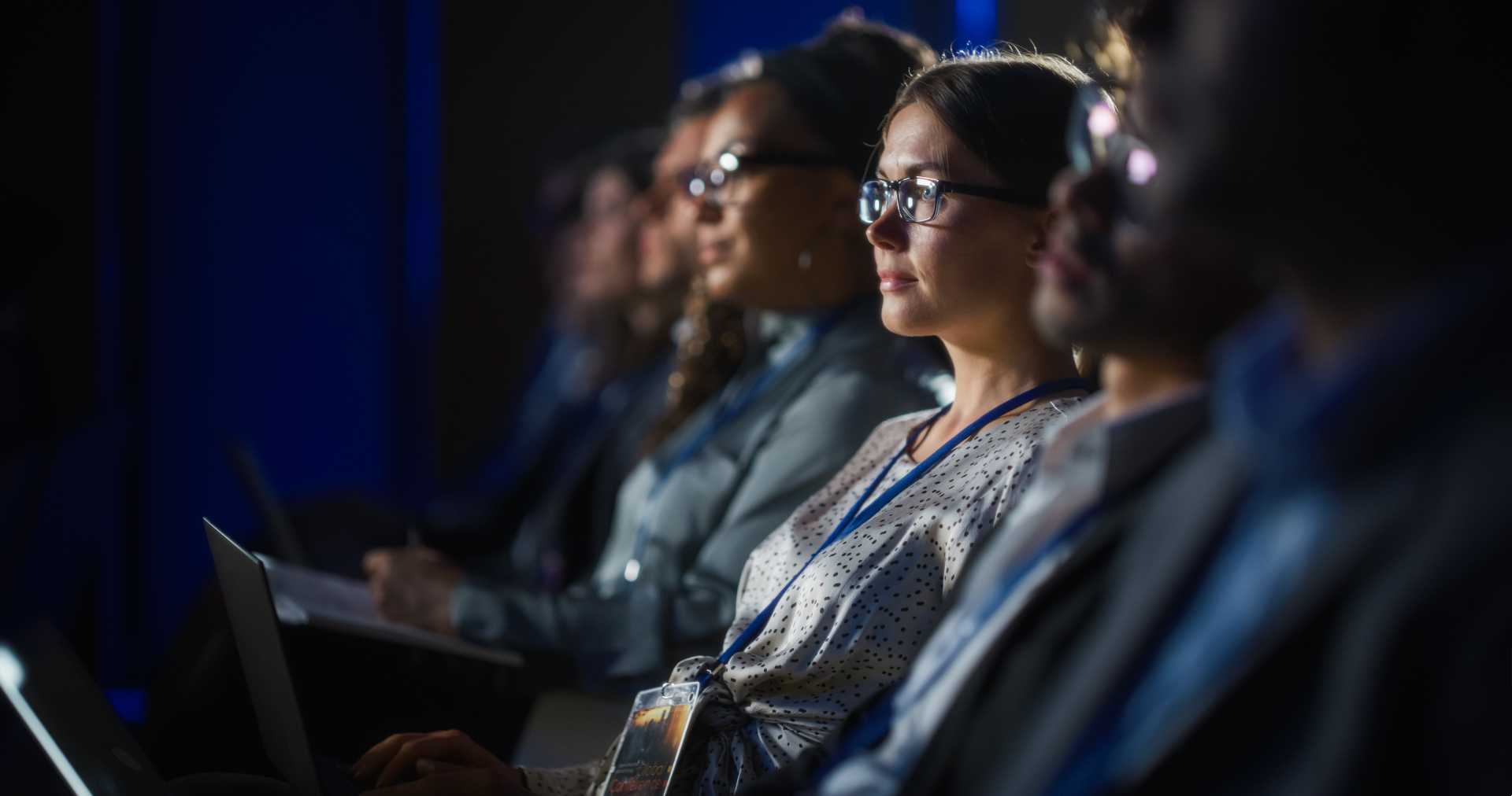 Group of people sitting together and viewing a presentation.