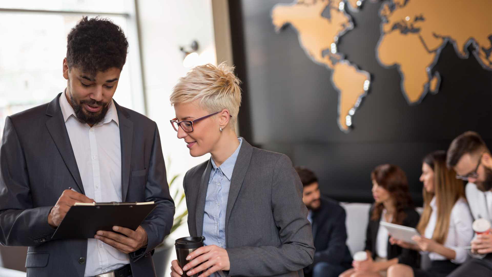 Man and Female co-worker looking at a project.
