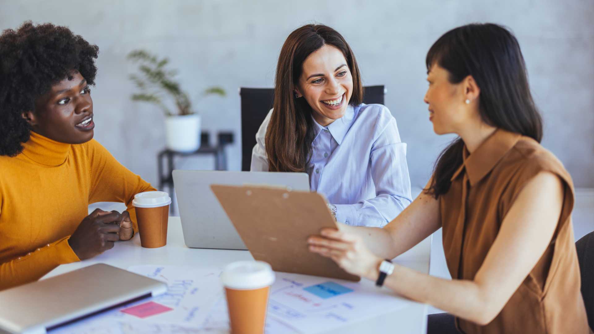 A group of women conversing in an office space