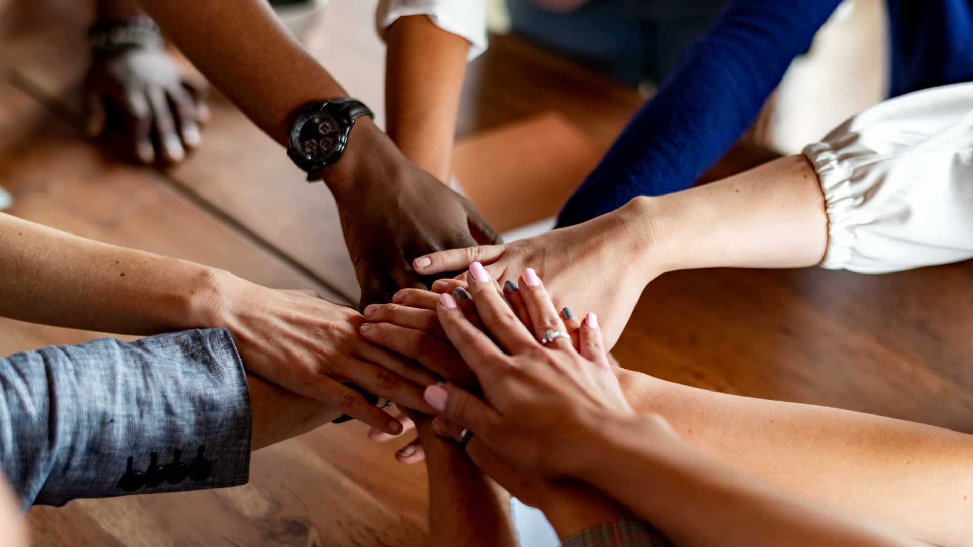 A group of people doing a handshake.
