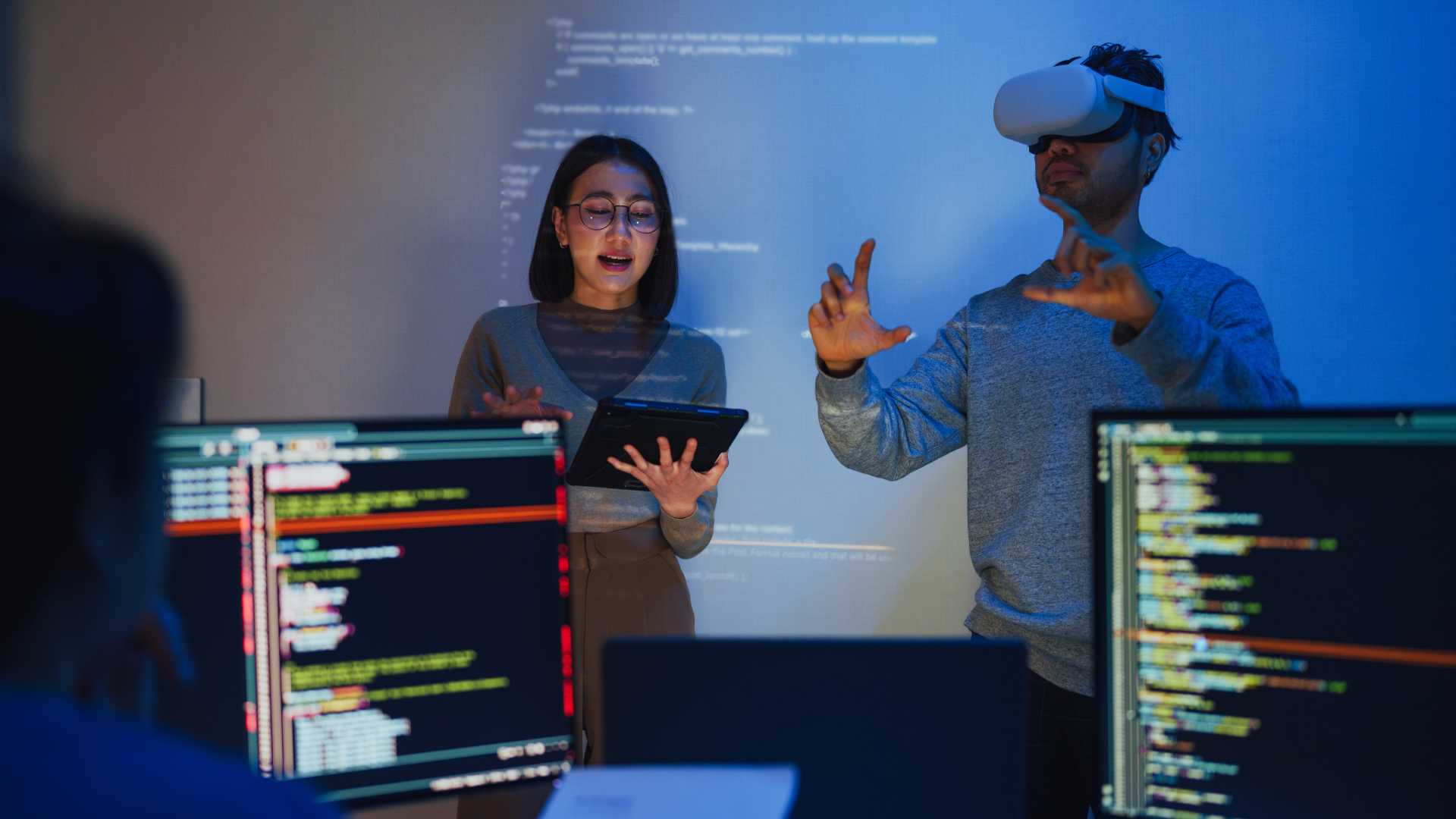 Coworkers using a virtual headset.