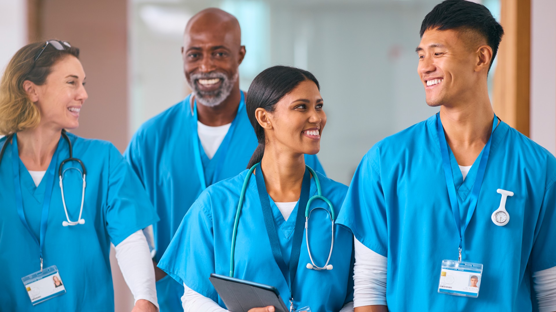 People working in medical field walking together and discussing something.