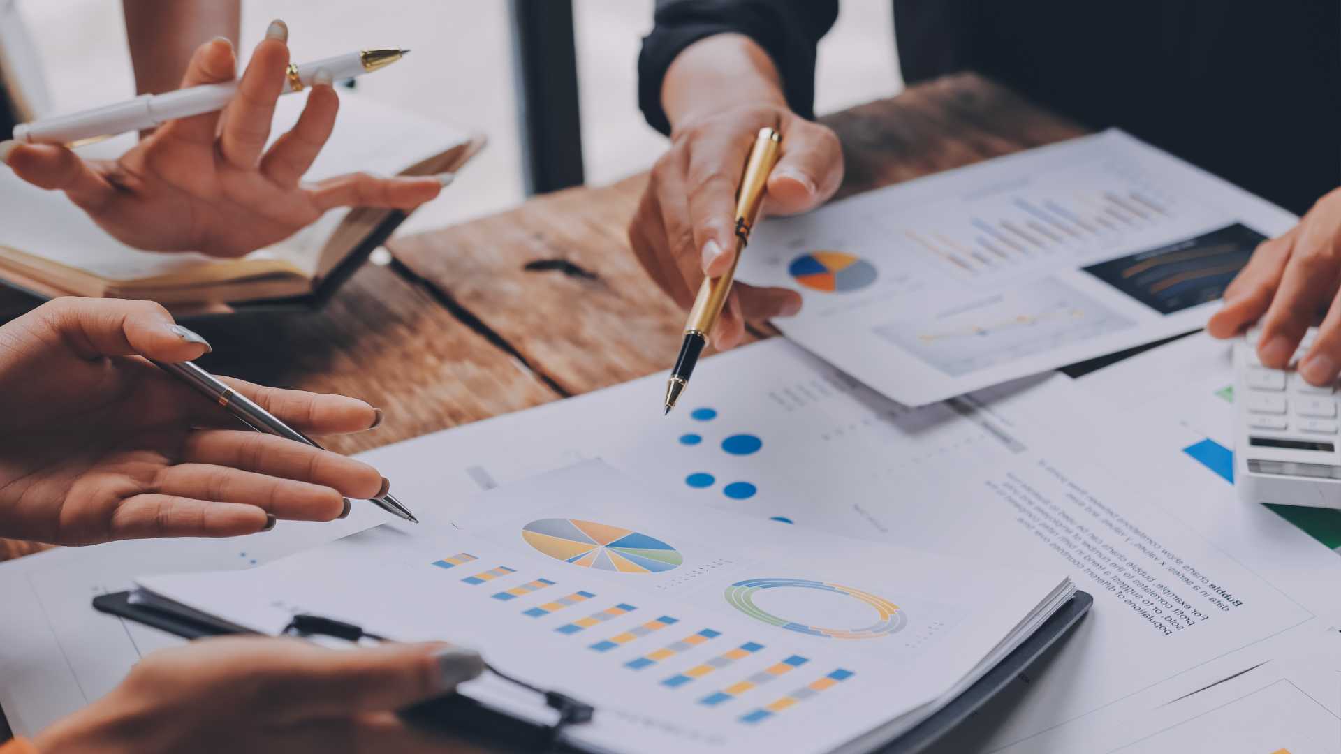 Group looking at pie charts for data.