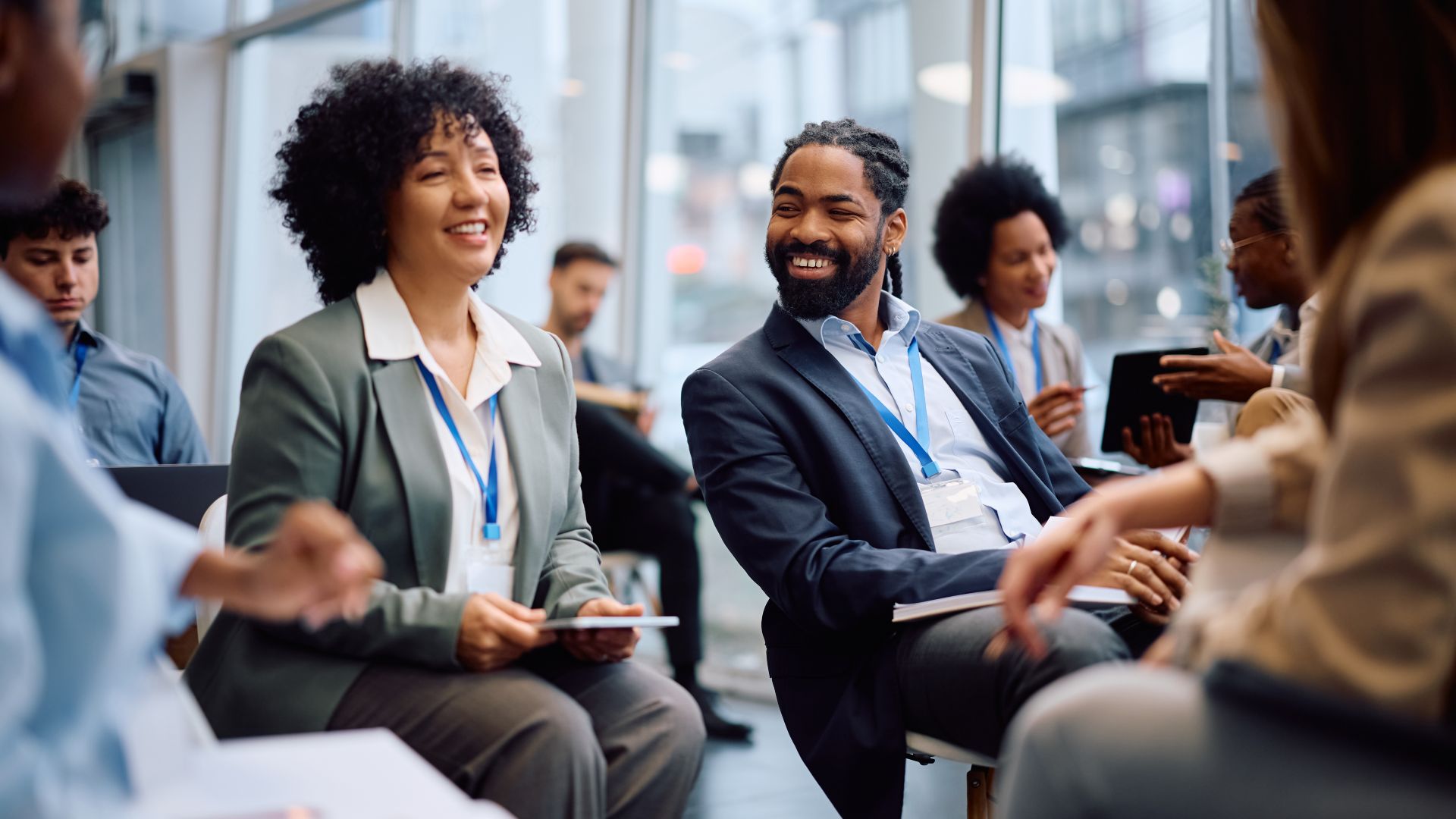 Professionals smiling and talking during a business conference.
