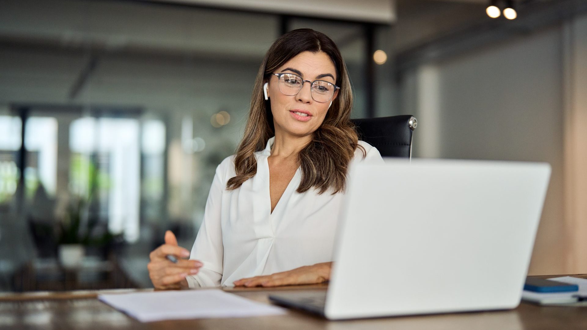 Woman staring at computer screen for work.